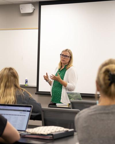 Social Work Program Director Toni Jensen in the front of a classroom teaching.