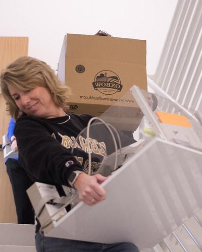 Psychology department staff move boxes.