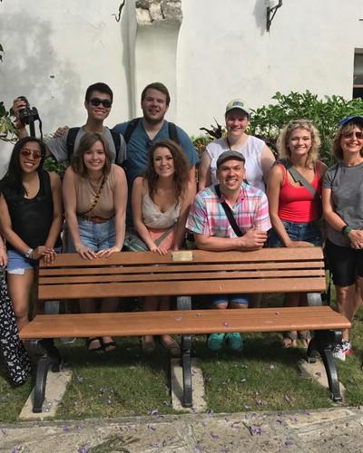 Students gather around a bench