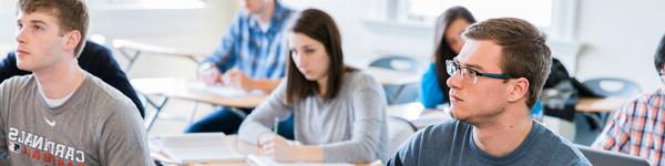 Classroom of male and female students sitting at desks.