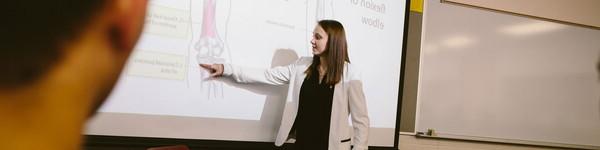 Professor Tamra Llewellyn in the front of a class