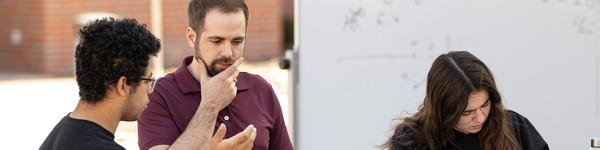 Math Professor Brent McKain teaches class outdoors with a rolling white board.