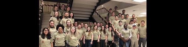 A large group of students standing on and around two staircases.