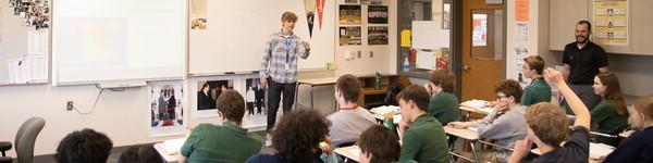 In a high school classroom, an NWU 教育 major student teaches a class. 